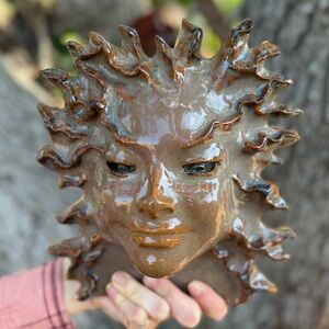 Vintage Hand Crafted Green Lady pottery wall hanging mask in brown glaze.
